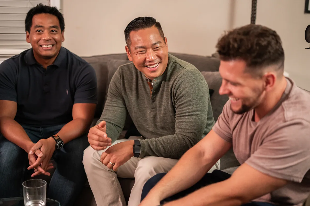 Men laughing together at a Dinner Group
